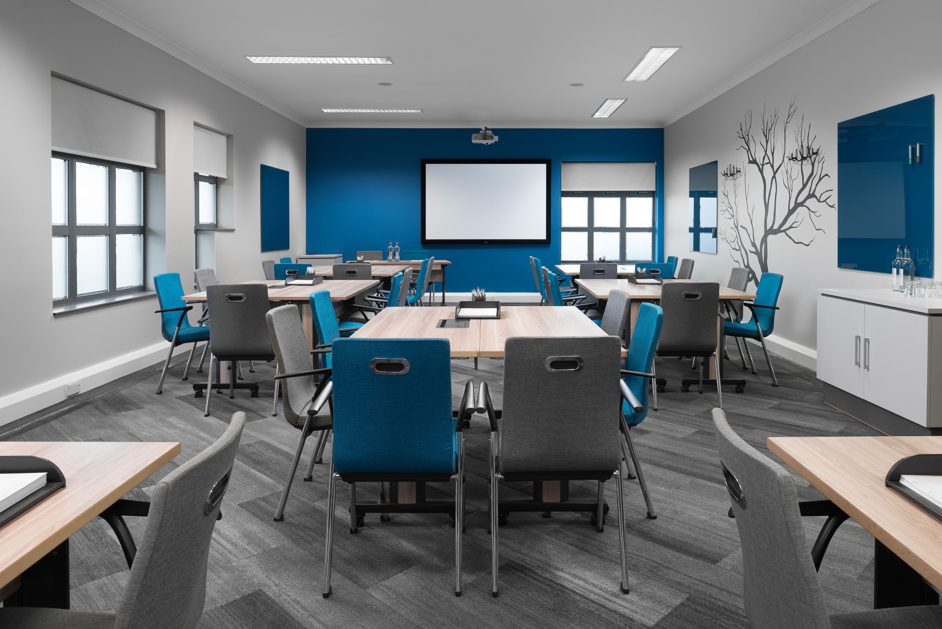 modern training room with blue and grey chairs and tables